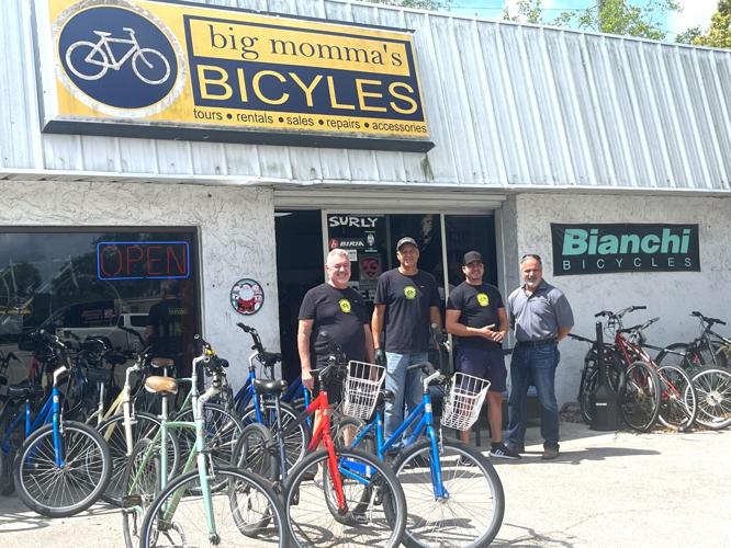 Big Momma’s Bicycles owner Sal Iandimarino with two of his employees, Lenny Perez and Rey Chea, and a customer. Photo by Aisling Swift